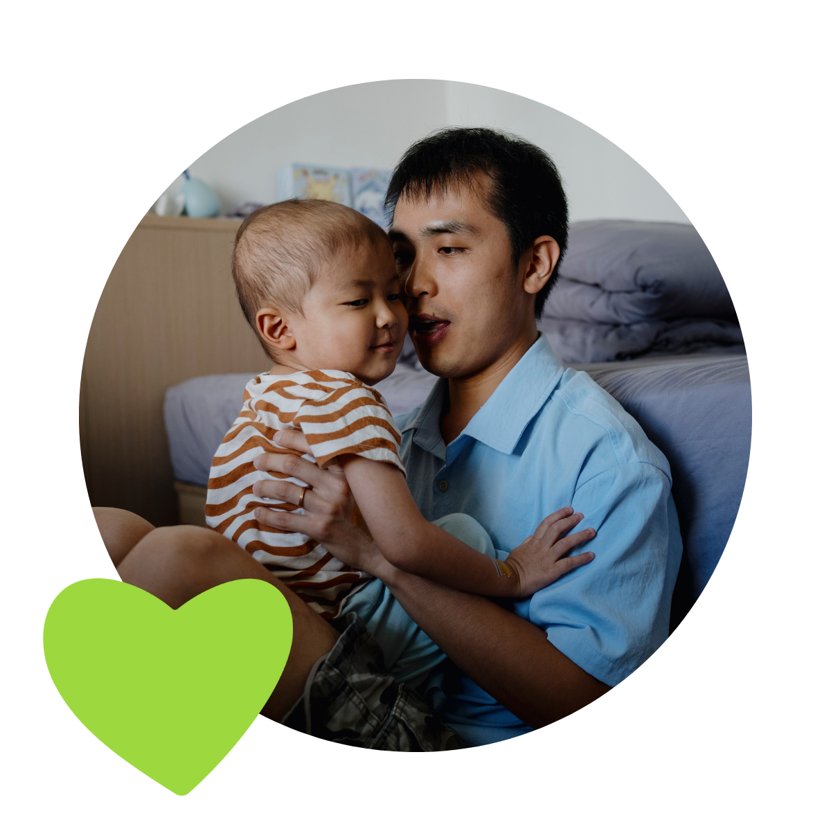 Dad sitting on the floor with child on his lap